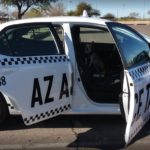 A white taxi with its doors open